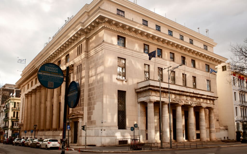 Street view of the National Bank of Greece with neoclassical columns at the entrance from Tsimiski Street in Thessaloniki.