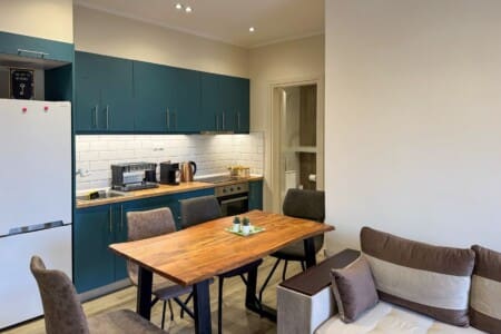 Modern one-bedroom apartment with stylish living room, fully equipped kitchen, terrace, and contemporary design for a comfortable stay in Moudania.