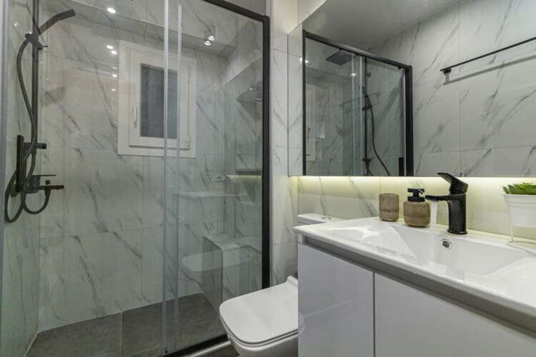 Modern two-bedroom apartment with stylish living room, fully equipped kitchen, balcony, and contemporary design for a comfortable stay in Thessaloniki.