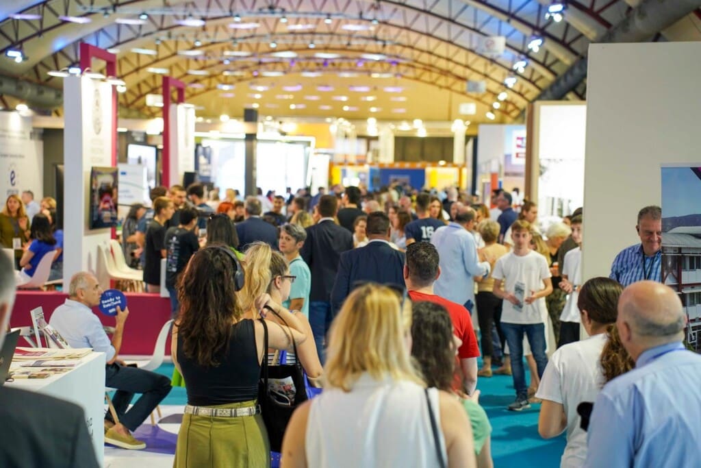 Visitors exploring booths inside the exhibition halls of the Thessaloniki International Fair.